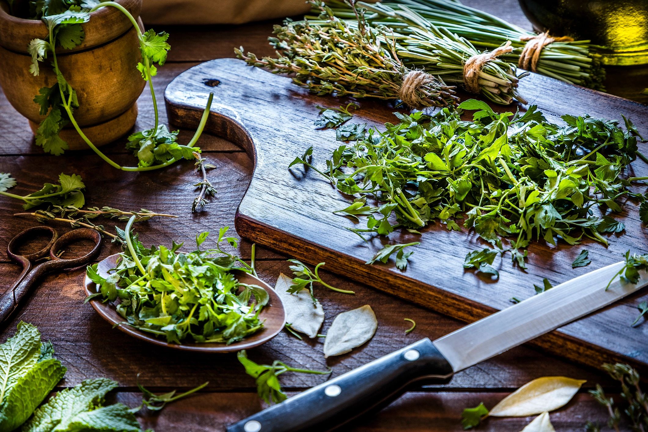 Fresh herbs on a rustic kitchen table